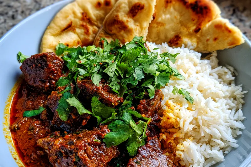 A photo of Savory Slow Cooker Beef Curry simmering in the slow cooker, showcasing the rich colors and textures.