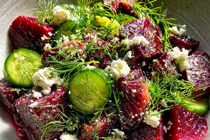 Fresh ingredients for Vibrant Beet Feta Salad with Fresh Dill arranged on a cutting board